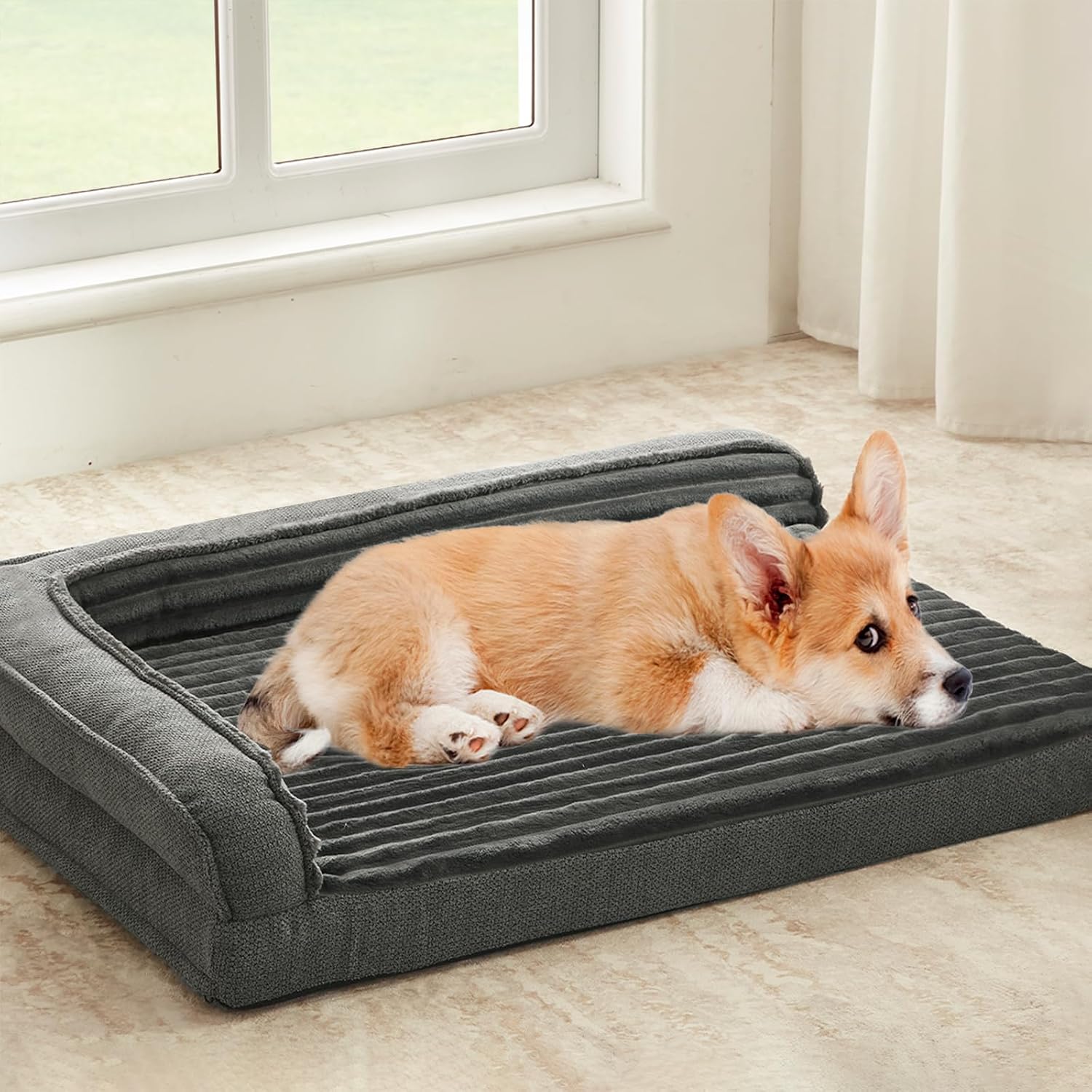 Grey L-shaped sofa-style pet bed with three-sided bolsters
